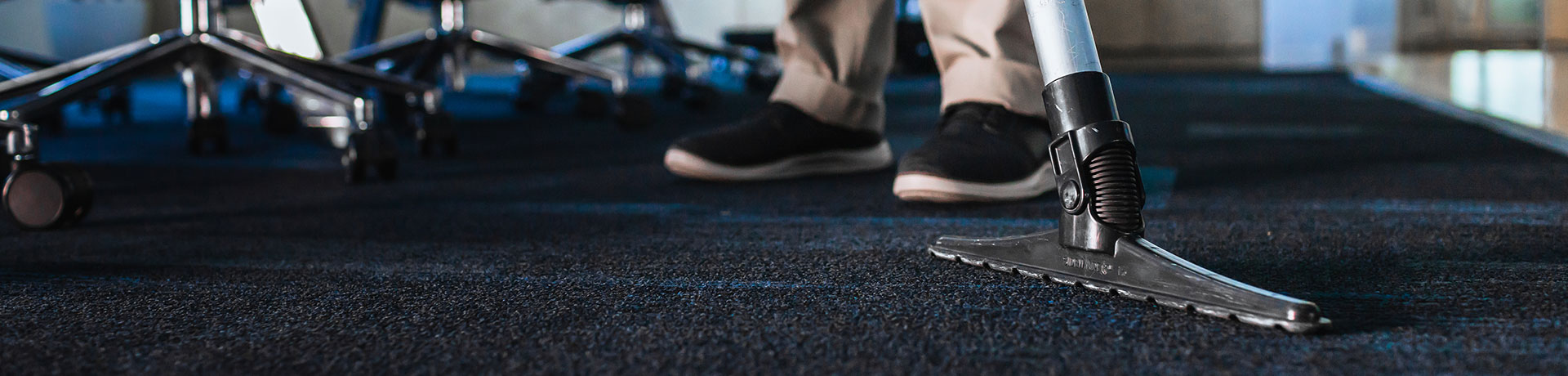 ServiceMaster Clean professional performing commercial carpet cleaning services with a commercial carpet cleaner